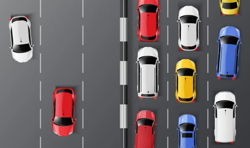 Aerial view of diverse vehicles on a multi-lane road, illustrating traffic patterns.
